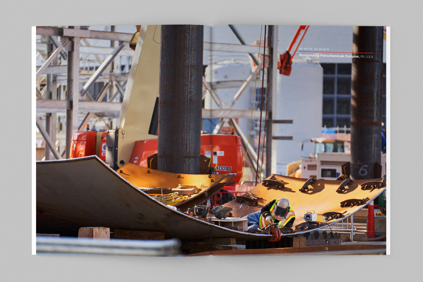 Full-bleed spread showing photograph of Bechtel worker at the Pennsylvania Petrochemicals Complex in the annual report design