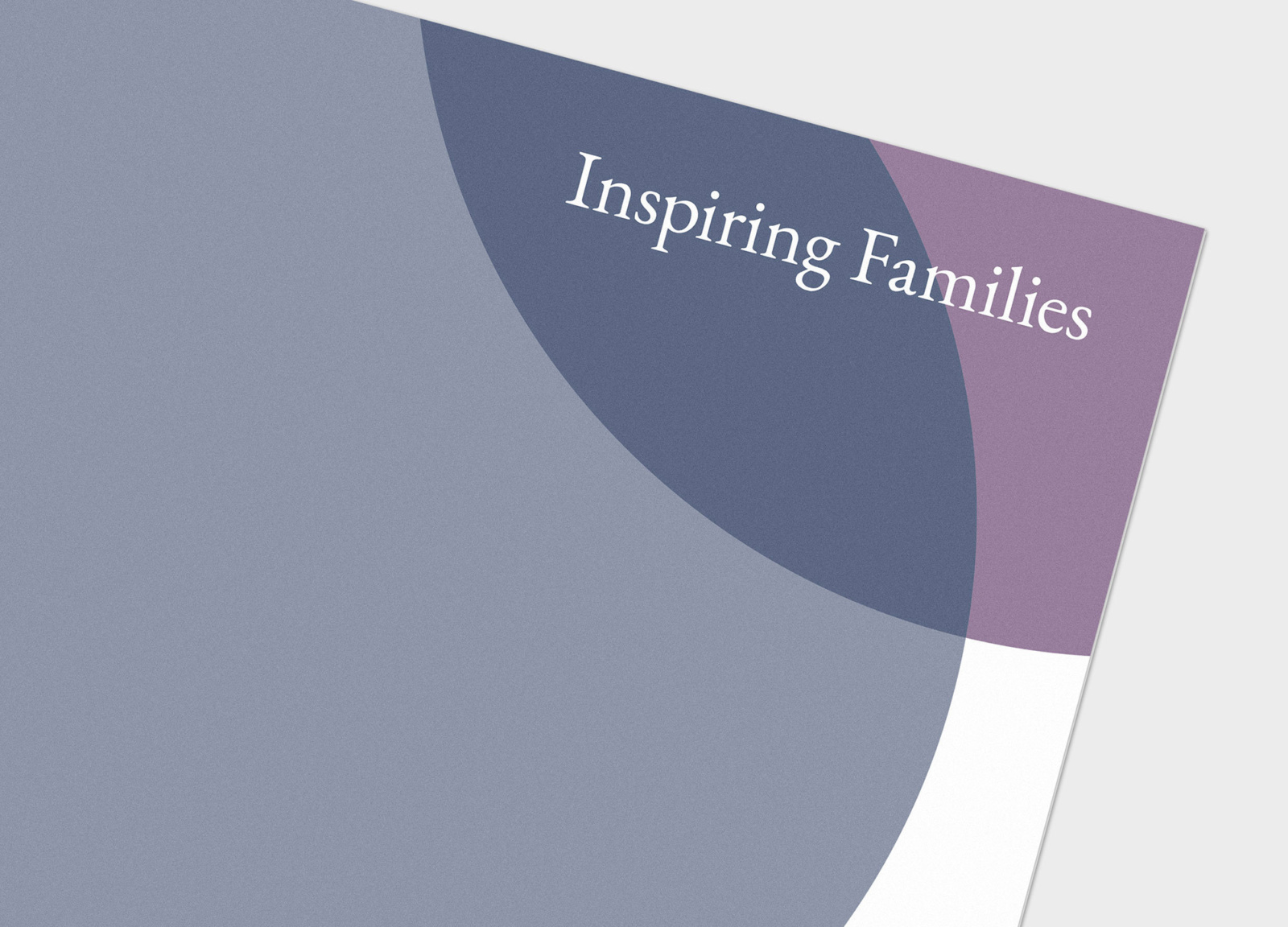 Detailed view of the pocket folder, bearing the tagline of the Fairport Wealth identity system, “Inspiring Families”